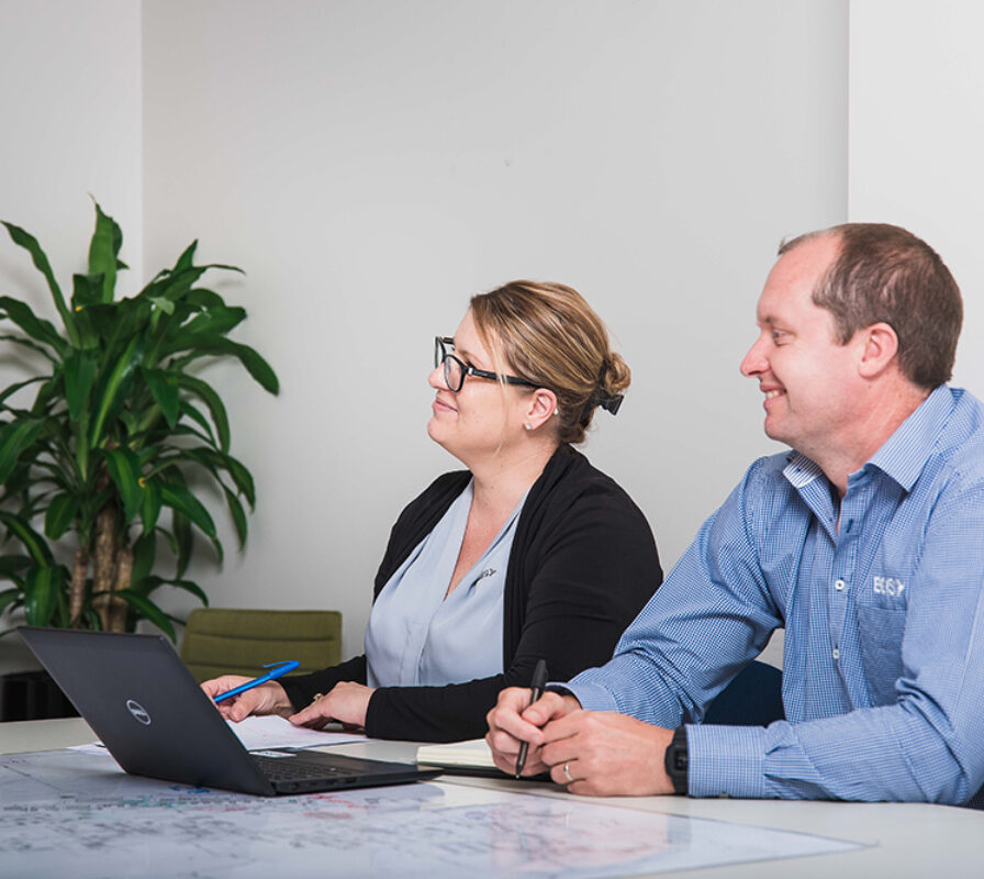 A man and woman working together in an office