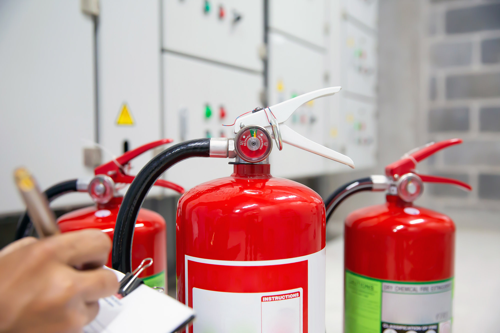 Engineer are inspection Fire extinguisher in fire control room for emergency, rescue and safety