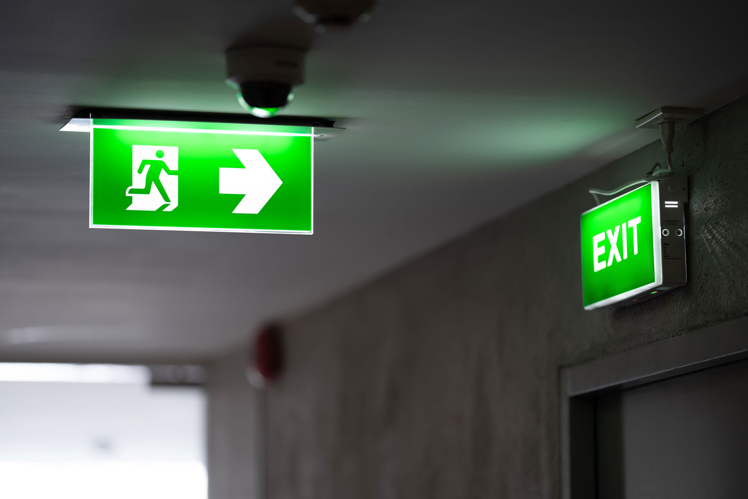 fire exit sign on white ceiling