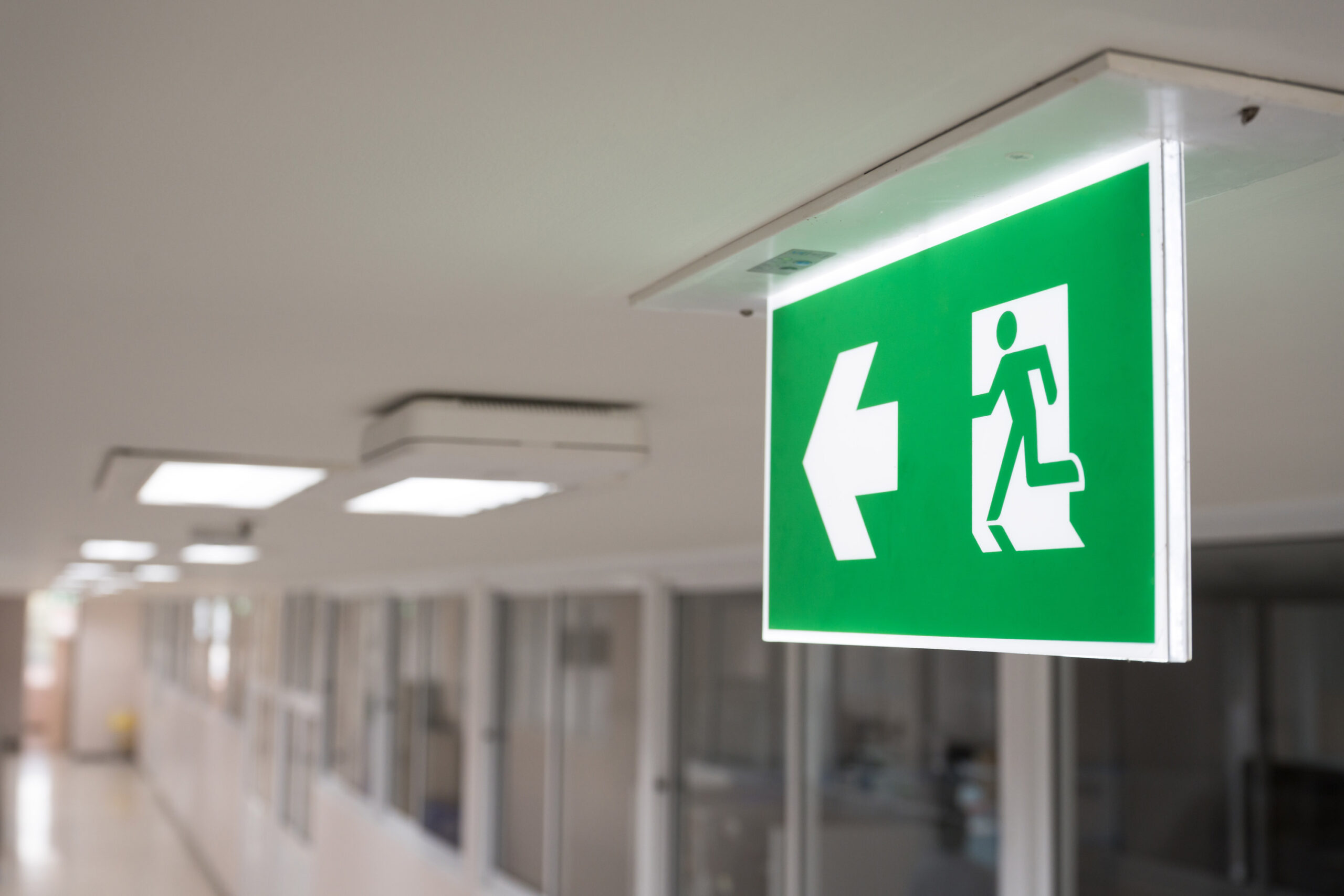 fire exit sign on white ceiling